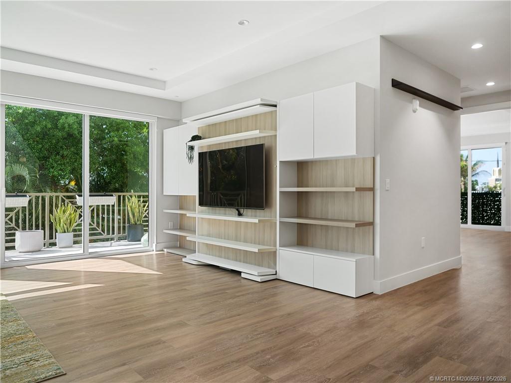 41 Southwest Seminole Street, Unit 208 Stuart, FL 34994 - Photo 17 of 46 a view of a room with wooden floor and windows