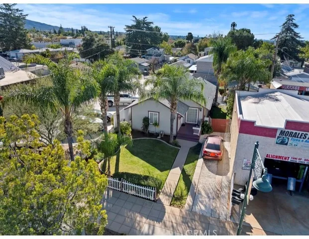 an aerial view of a house with outdoor space patio and outdoor seating