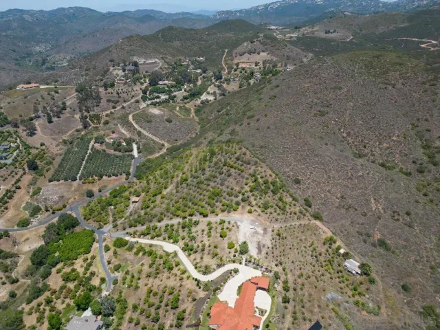 a view of a dry yard with wooden fence
