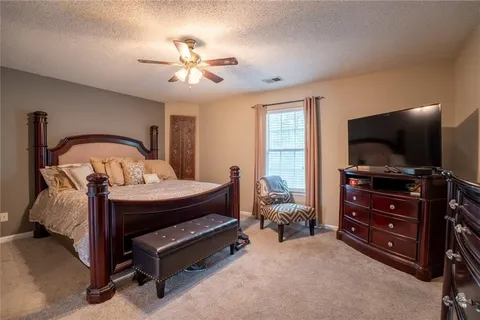 a bedroom with furniture and a flat screen tv