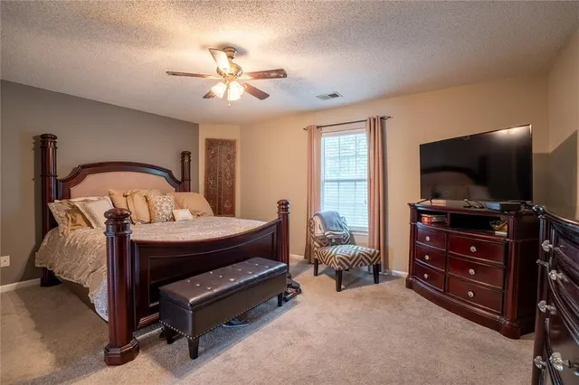 a bedroom with furniture and a flat screen tv