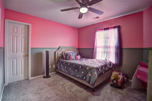 a living room with furniture a flat screen tv and a window