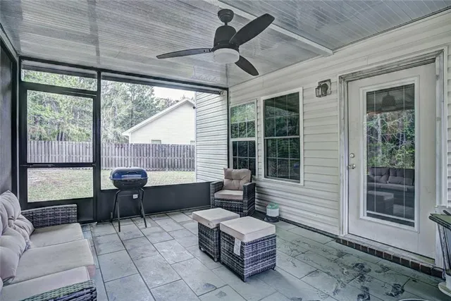 a living room with furniture and a floor to ceiling window