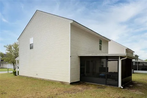 a view of a house with backyard porch and sitting area