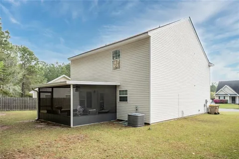 an aerial view of a house with a backyard