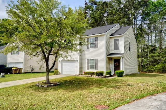 a front view of a house with a yard