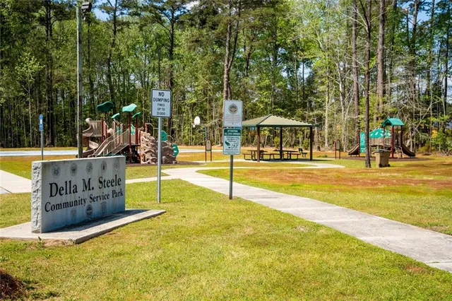 a view of a house with a yard and potted plants