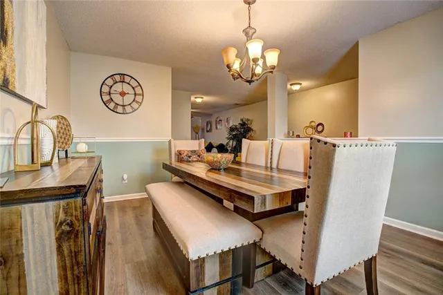 a view of a dining room with furniture and a chandelier