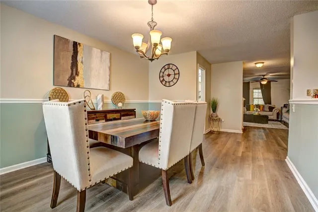 a view of a dining room with furniture wooden floor and a chandelier