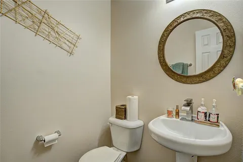 a bathroom with a toilet a sink and a mirror