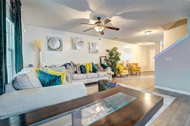 a living room with furniture and wooden floor