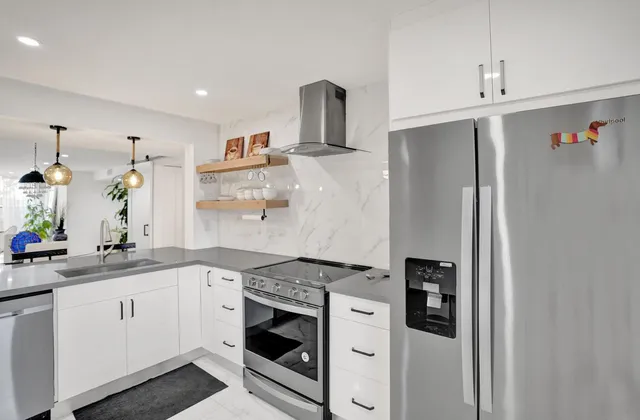 a living room with furniture and potted plants