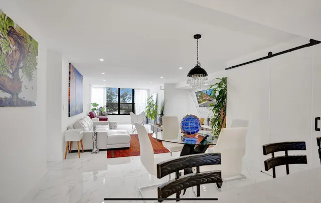 a living room with furniture and wall paintings