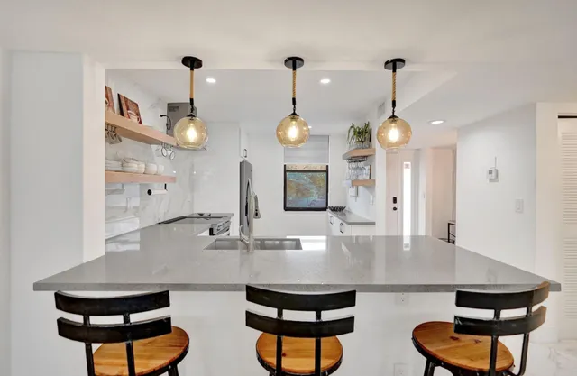 a bedroom with a bed and a flat tv screen on dresser