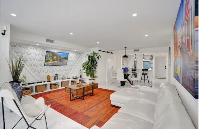 a bathroom with a granite countertop shower sink vanity mirror and toilet