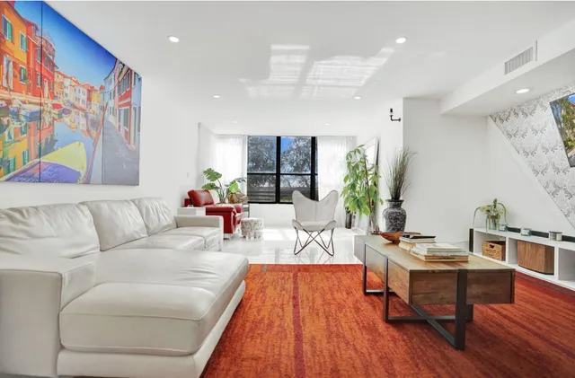 a bathroom with a double vanity sink a toilet and shower