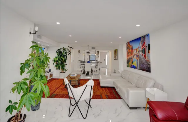 a bedroom with a bed and painting on the wall