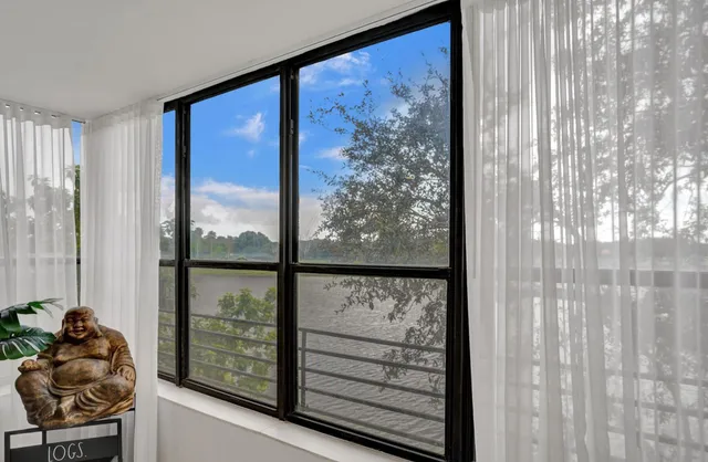 a living room with lots of furniture and a book shelf