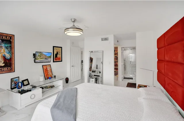 a view of a swimming pool with a bench and lawn chairs under an umbrella
