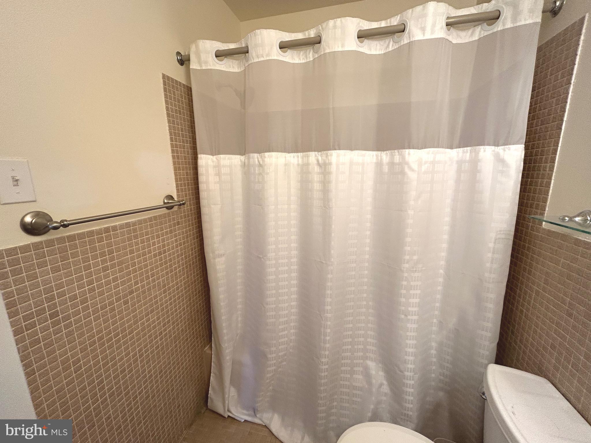 7 Rockford Road, Unit K022 Wilmington, DE 19806 - Photo 11 of 15 a bathroom with a shower curtain and sink