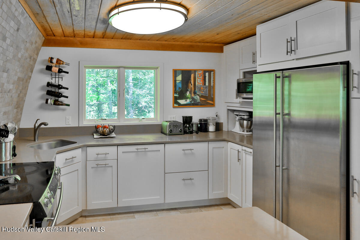 3 Quarry Road Shandaken, NY 12480 - Photo 17 of 29 a kitchen with stainless steel appliances granite countertop a refrigerator sink and cabinets