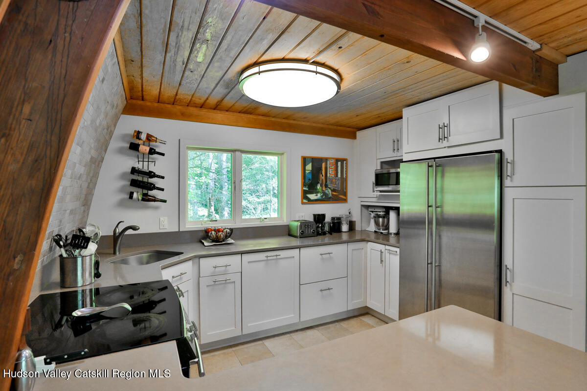 3 Quarry Road Shandaken, NY 12480 - Photo 18 of 29 a kitchen with stainless steel appliances a sink a stove a refrigerator and a window