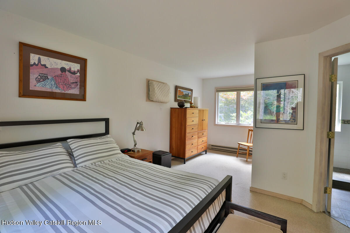 3 Quarry Road Shandaken, NY 12480 - Photo 23 of 29 a bedroom with a bed and a large mirror next to a window