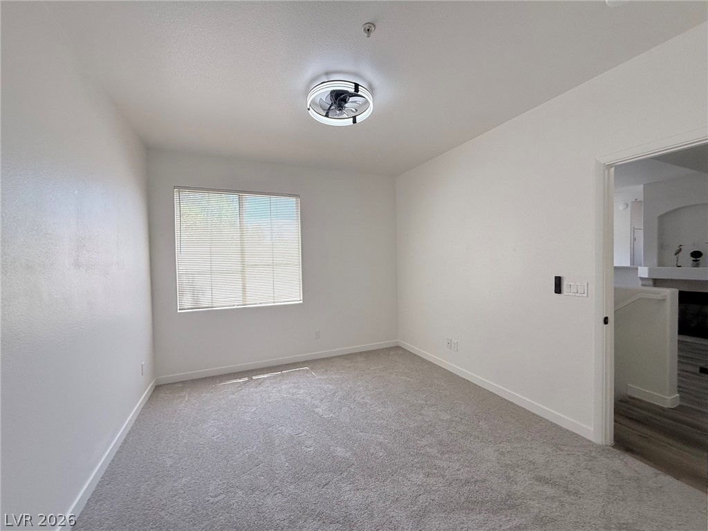 9050 West Warm Springs Road, Unit 2002 Las Vegas, NV 89148 - Photo 23 of 46 Bright and airy room with plush carpeting and natural light, ready for your personal touch.