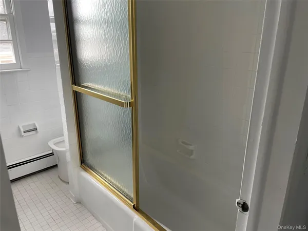 a bathroom with a glass shower door