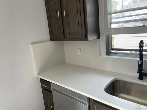 a kitchen with a sink and a window