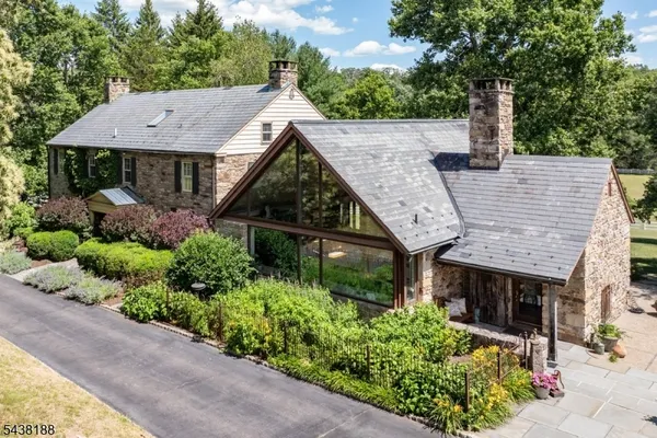 aerial view of a house with a yard and potted plants