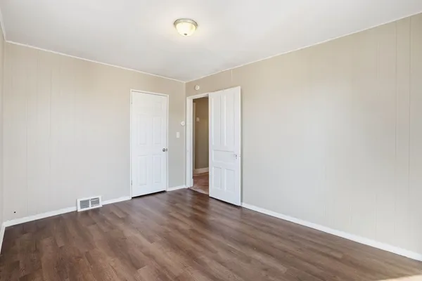 an empty room with wooden floor
