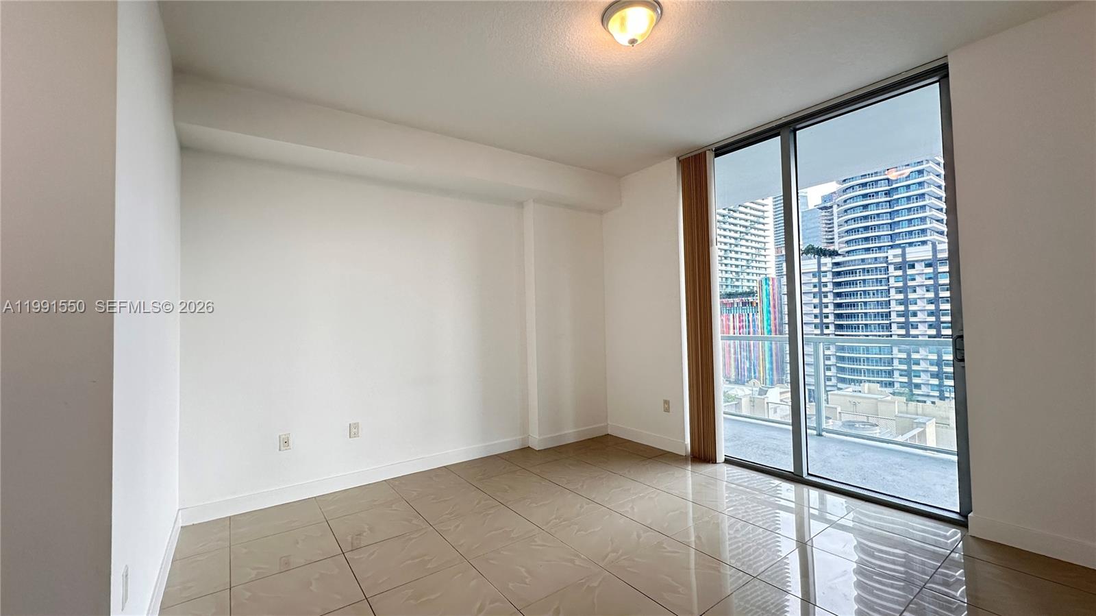 79 Southwest 12th Street, Unit 1102S Miami, FL 33130 - Photo 11 of 24 an empty room with windows