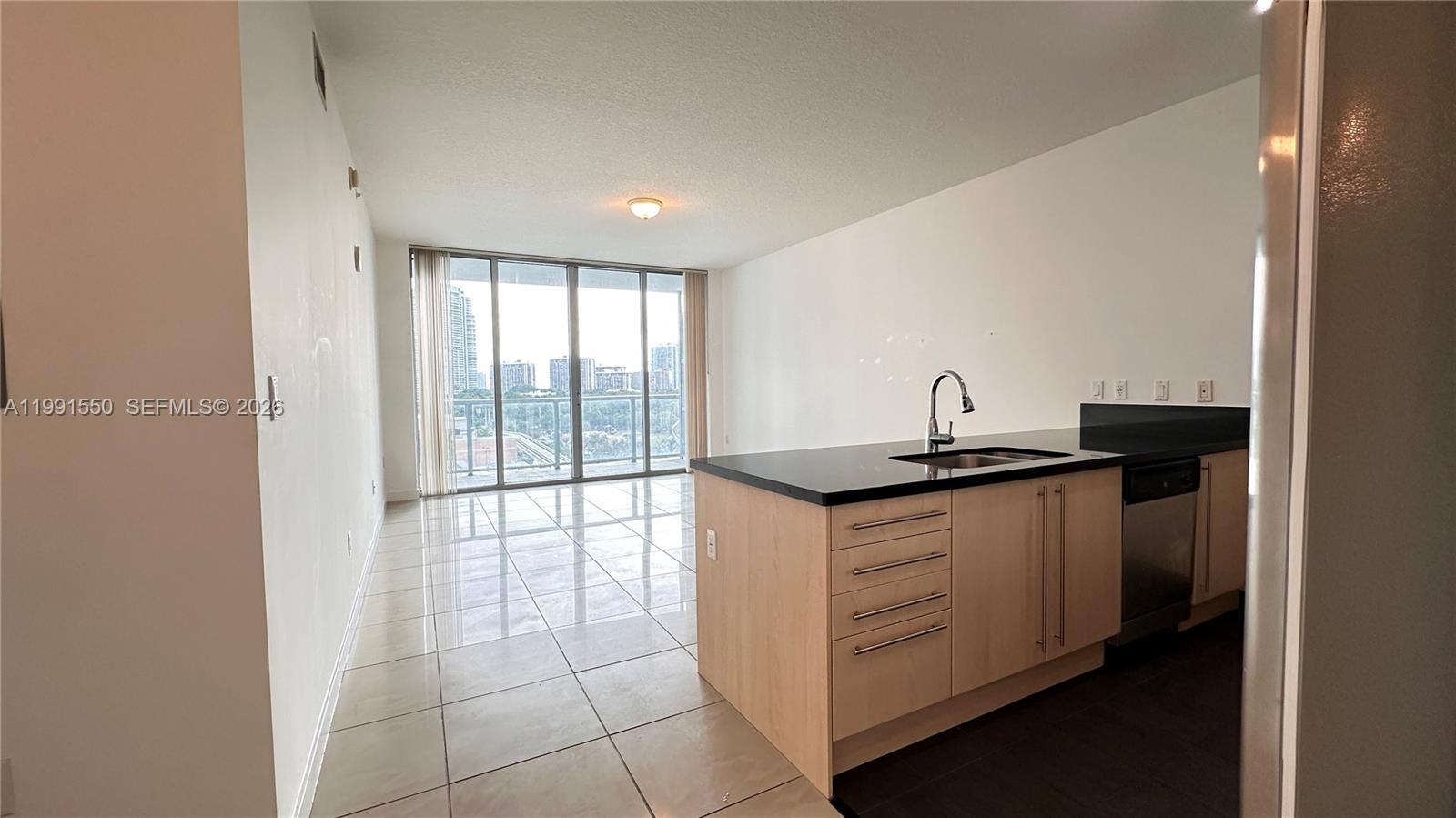 79 Southwest 12th Street, Unit 1102S Miami, FL 33130 - Photo 2 of 24 a kitchen with a sink and a window