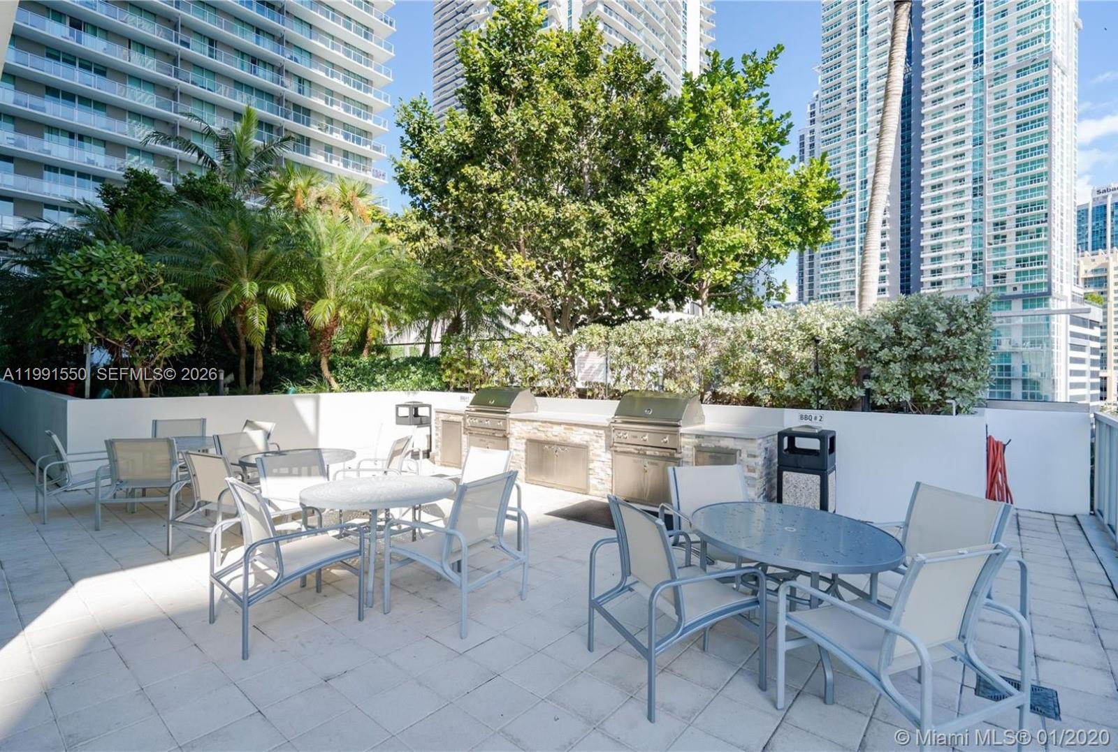 79 Southwest 12th Street, Unit 1102S Miami, FL 33130 - Photo 22 of 24 a view of a patio with a table and chairs and couches
