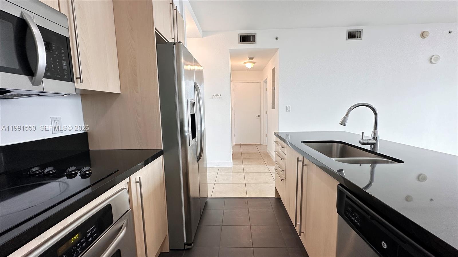 79 Southwest 12th Street, Unit 1102S Miami, FL 33130 - Photo 5 of 24 a kitchen that has a sink and a stove