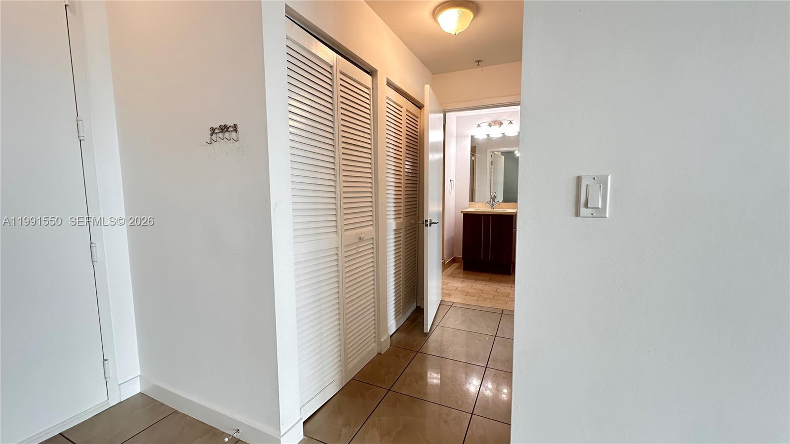 79 Southwest 12th Street, Unit 1102S Miami, FL 33130 - Photo 9 of 24 a view of a hallway with a closet