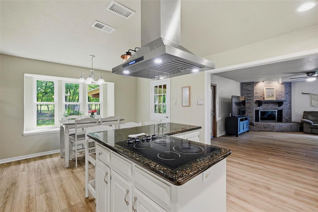 522 High Country Road Sherman, TX 75092 - Photo 11 of 38 a kitchen with stainless steel appliances granite countertop a stove and a wooden floors