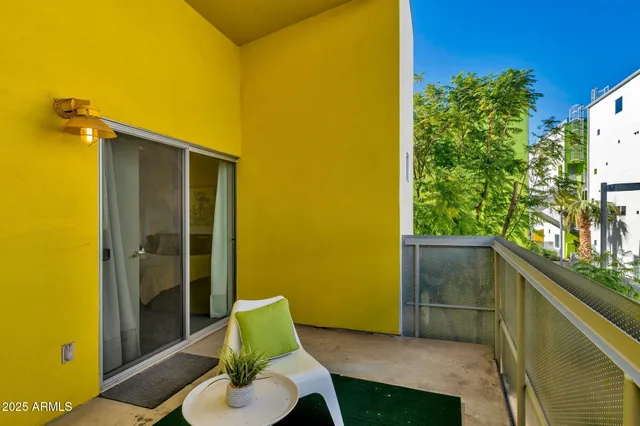 a balcony with furniture and a potted plant
