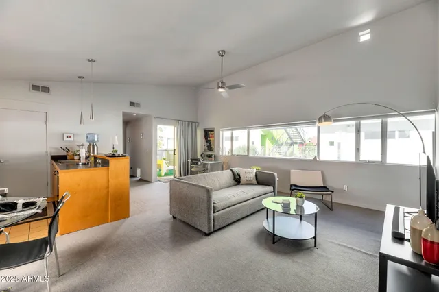 a living room with furniture a window and a dining table