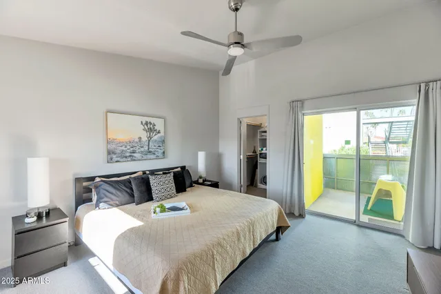 a bedroom with a bed and a painting on the wall