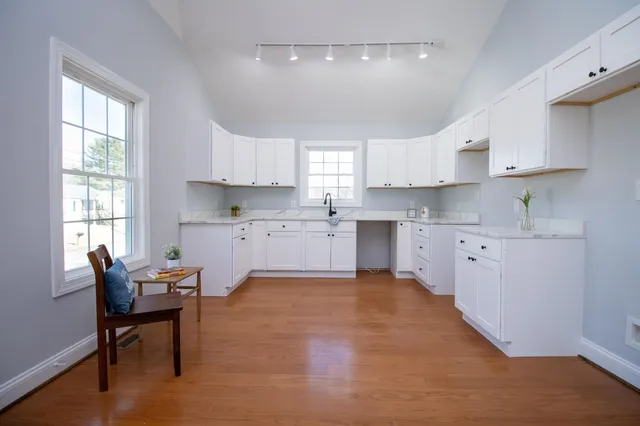 a kitchen with cabinets a sink and a window