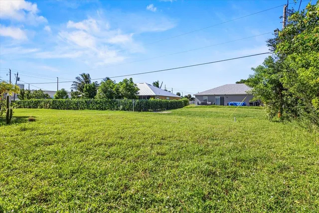 a view of a big yard with a house in the background