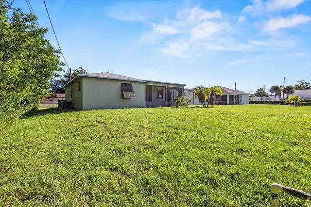 a view of a field of grass and trees