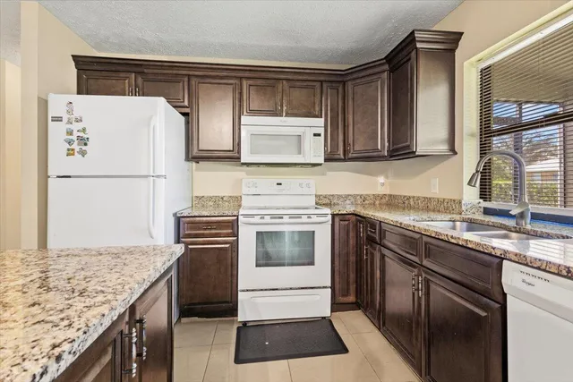 a kitchen with a sink stove and refrigerator