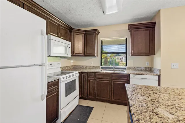 a kitchen with a stove sink and cabinets