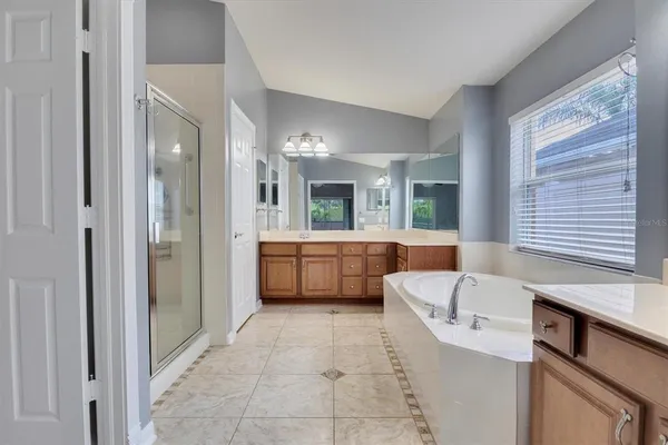 wooden floor in an empty room with a ceiling fan
