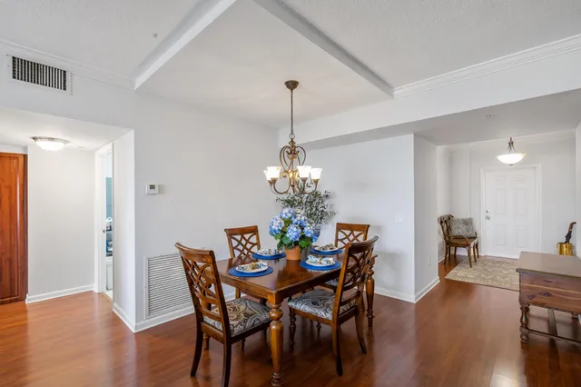 a view of a dining room with furniture wooden floor and chandelier