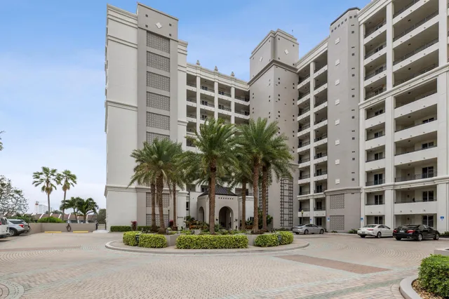 a front view of a residential apartment building with a yard