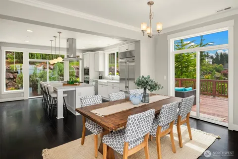 a dining room with furniture wooden floor and a chandelier